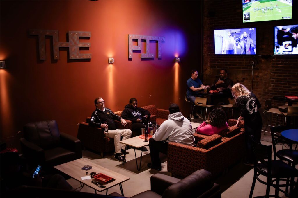 Guests on leather sofas in the lounge area called The Pit at Classic Cigars